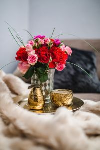 Kaboompics - Romantic Red and Pink Roses Styled on a Dark Sofa