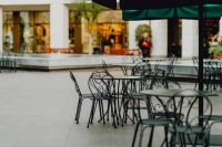 Kaboompics - Outdoor Cafe Seating under Green Umbrellas