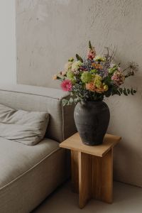 Kaboompics - Tall Floral Arrangement in Charcoal Vase on a Woven Stool