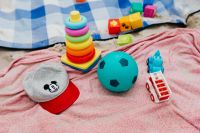 Kaboompics - Colorful Stacking Rings, Toy Blocks and Ball on Beach Towels for Family Vacation