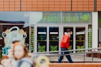 Kaboompics - Food Court Entrance with Chef Illustration and Pedestrian at Manufaktura, Łódź, Poland