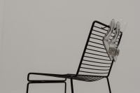 Kaboompics - Transparent High Heels on a Black Wire Chair with Copy Space