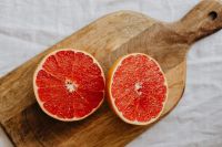Kaboompics - Grapefruit Halves on a Wooden Cutting Board for Recipe Prep