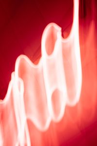 Kaboompics - Bright Neon Light Curves on Vibrant Red Background