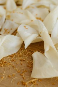 Kaboompics - White Flower Petals and Pollen on a Wooden Background