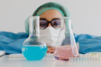 Kaboompics - Female Scientist Framed by Laboratory Flasks