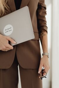 Kaboompics - Close-Up of Woman Holding Laptop and Eyeglasses