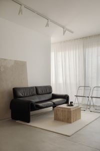 Kaboompics - Minimalist Living Room with Black Sofa and Travertine Table