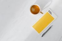 Kaboompics - Top view of a marble desk with coffee, notebooks and pen