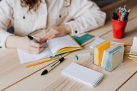 Kaboompics - Woman Writing in Notebook with Colorful Stationery