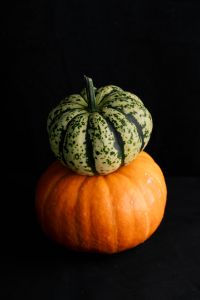 Kaboompics - Green Striped Pumpkin Stacked on Orange Pumpkin