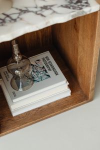 Kaboompics - Photography Book and Glass Candle Holder on a Wooden Bookshelf