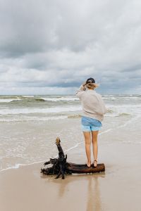 Kaboompics - Woman with a Driftwood Branch on the Beach