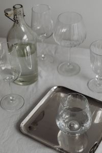 Kaboompics - Glass Bottle and Wine Glasses on Silver Tray over White Tablecloth