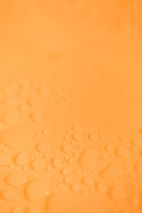 Kaboompics - Orange Water Droplet Background With Copy Space Above