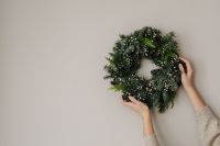 Kaboompics - Close Up of Hands Holding Evergreen Christmas Wreath