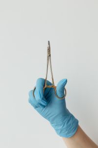 Kaboompics - Gloved Hand Holding a Crile-Wood Needle Holder