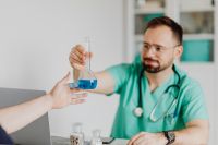 Kaboompics - Patient Receiving Laboratory Flask From Doctor