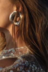 Kaboompics - Silver Statement Earring and Sequin Dress Close Up