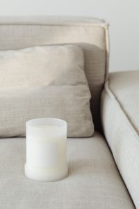 Kaboompics - Close Crop of a White Candle Jar and Blank Label on Linen