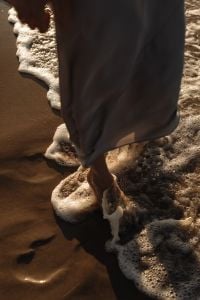 Kaboompics - Barefoot Woman Walking Through Sea Foam in Long Dress