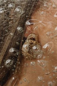 Kaboompics - Gold Jewelry Detail on Skin Through Water Droplets