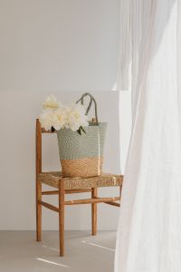 Kaboompics - Woven Flower Tote on a Wooden Chair in a Bright Neutral Interior
