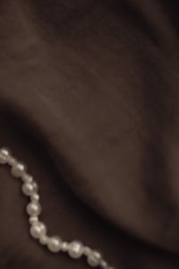 Kaboompics - Dark Fabric Background with a Soft-Focus Pearl Strand