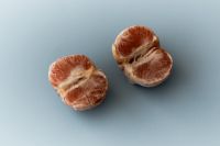 Kaboompics - Pink Grapefruit Halves on Blue Background