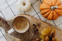 Kaboompics - Coffee Cup with Mini Pumpkins and Oak Leaves