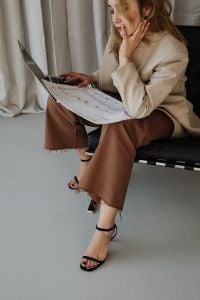 Kaboompics - Woman Checking a Printed Financial Report beside Her Laptop