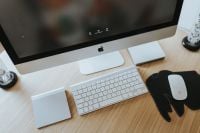 Kaboompics - White Apple iMac Keyboard and Mouse on a Black Elephant-Shaped Pad, Desktop Close-Up