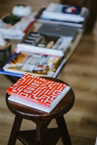 Laptop, a smartphone, magazines and cups of coffee on a table