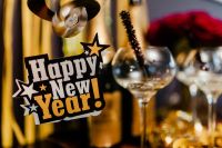 Kaboompics - Happy New Year Sign and Champagne Glasses in a Gold Streamer Party Setting