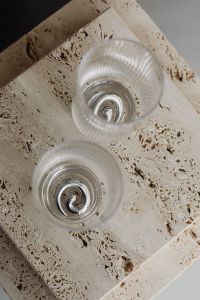 Kaboompics - Silver Spiral Earrings and Glassware from Above