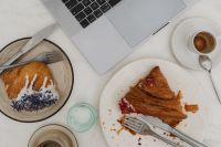 Kaboompics - Laptop Work Table with Croissants, Coffee and Water