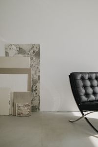 Kaboompics - Black Leather Chair Beside Neutral Art Panels