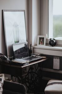 Workplace with a laptop and a notebook on a desk