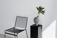 Kaboompics - Black Metal Chair and Flower Vase on a Pedestal