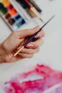 Kaboompics - A woman paints with watercolors