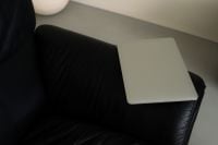 Kaboompics - Closed Silver Laptop on Black Leather Sofa