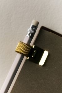 Kaboompics - Pencil Attached to Notebook with Black Binder Clip