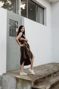 Kaboompics - Asian Woman Standing with Arms Crossed in Black Top and Brown Wrap Skirt