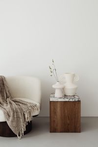 Kaboompics - Beige Armchair and Wooden Side Table with White Vases and Dried Grass
