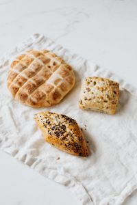 Kaboompics - Rustic Slovenian Bread and Seeded Roll with Copy Space, Bakery Menu Background
