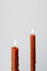 Kaboompics - Two Burnt Orange Taper Candles on a White Background