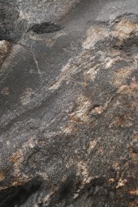 Kaboompics - Dark Slate-Like Coastal Rock with Fine Diagonal Striations and Pale Mineral Streaks