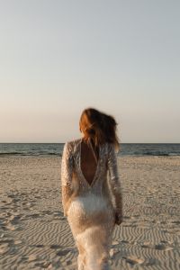 Kaboompics - Back View of Woman in Sequin Dress on Coastal Dunes