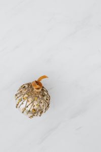 Kaboompics - Gold Bauble and Glitter Snowflake on White Marble Background