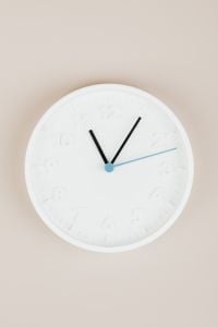 Kaboompics - Minimal White Analog Clock on Beige Surface